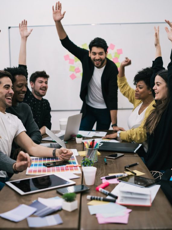 business-team-celebrating-with-raised-up-hands-.jpg