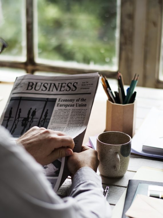 businesspeople-reading-newspaper-at-office-updating-news.jpg